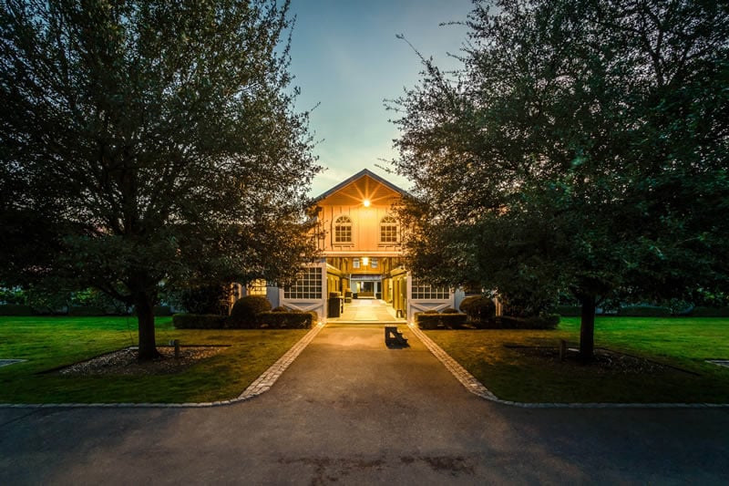 home with two big trees
